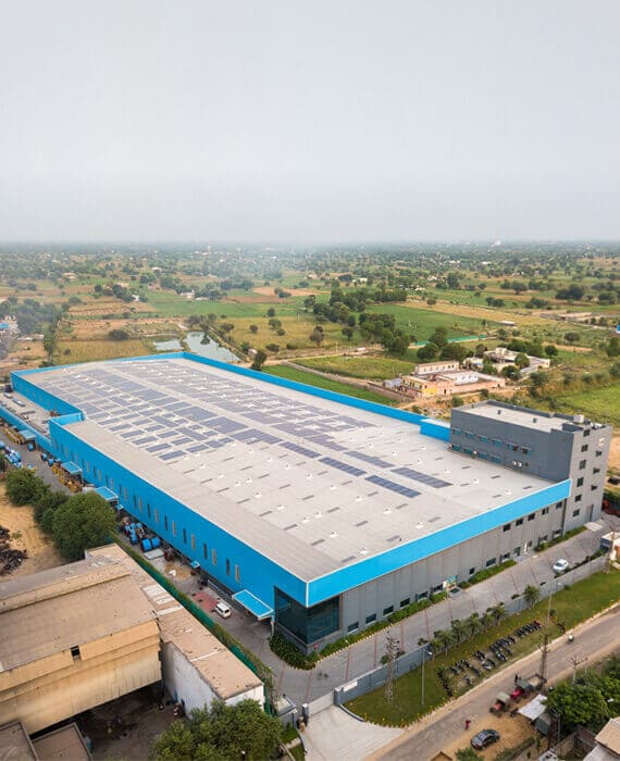 An aerial shot of wire factory with solar panels