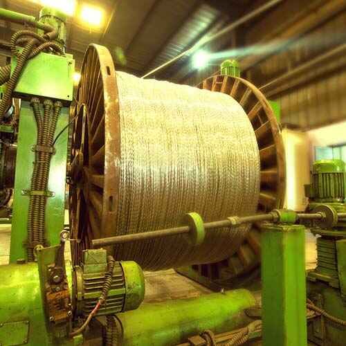 Machinery spinning and bundling a reel of wire and cable